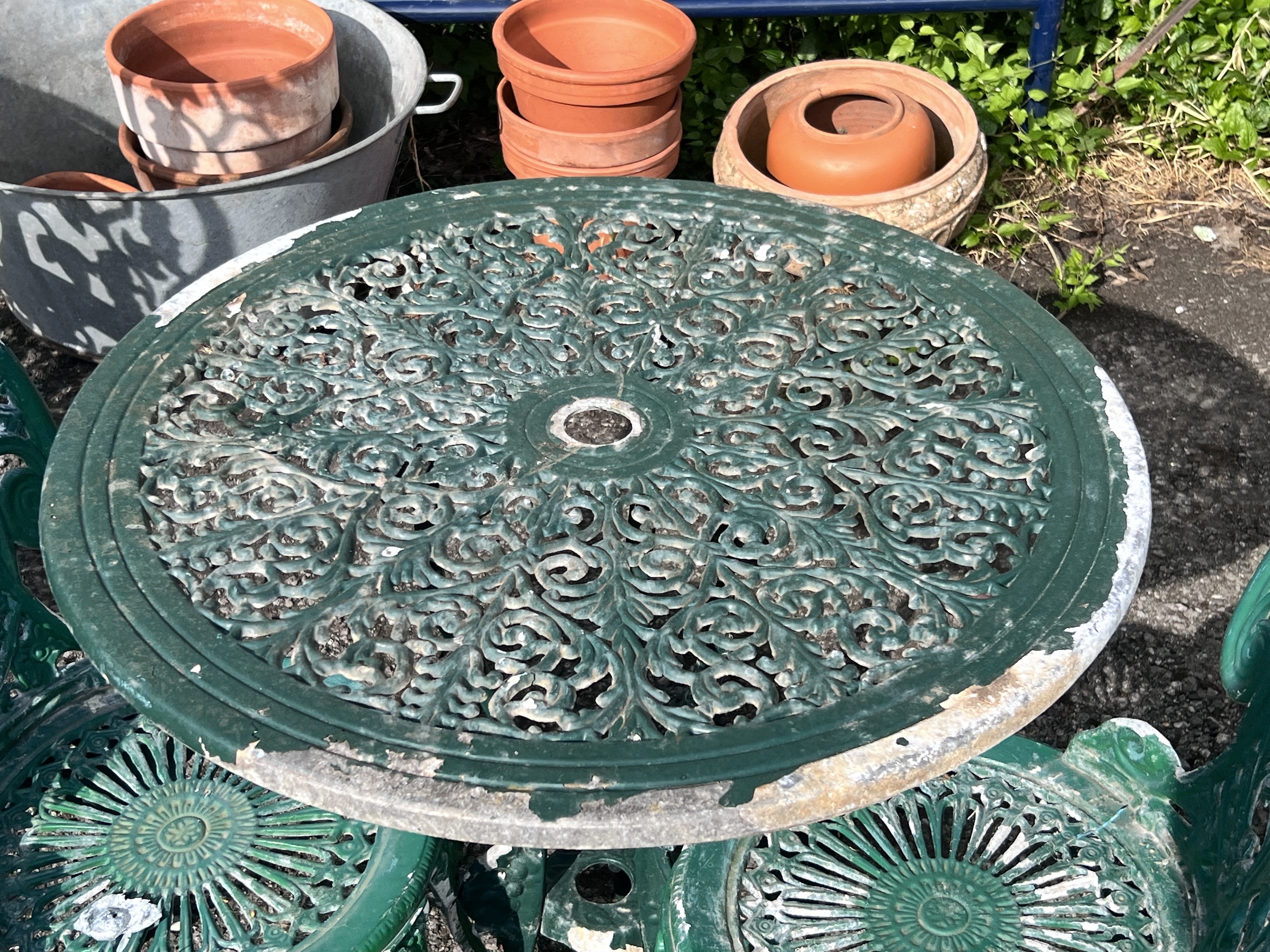 A circular aluminium garden table, diameter 69cm, height 72cm, together with two chairs